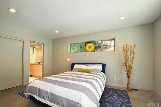 Ground floor bedroom number one with its own full bath... french doors are on the right which open to a private secluded grassy sitting area for morning coffee!