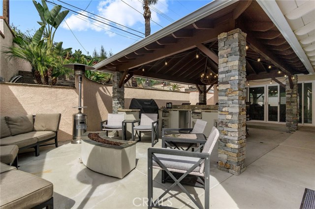 Another angle of the backyard with convenient access to the formal dining room and kitchen. Heat lamps and a fire pit for chilly evenings!