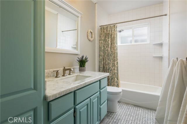 Bathroom featuring Carrara Marble floors and Quartzite countertops.