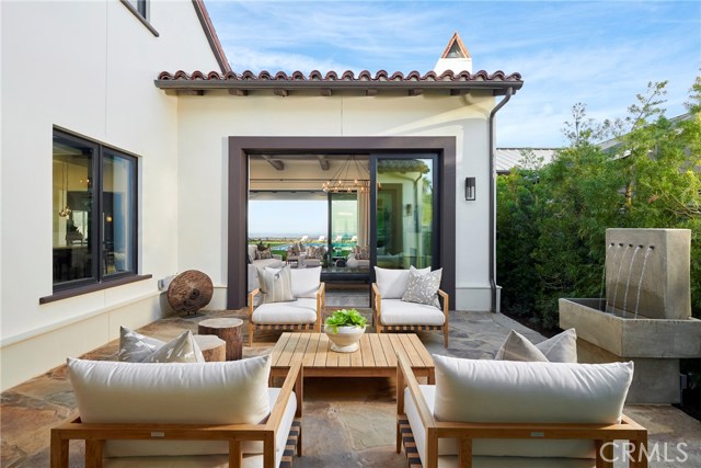 The entry courtyard with the open stacked sliders allowing easy & luxurious flow-through entertaining in this home.