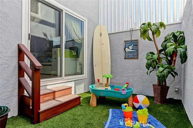 Remodeled atrium area with custom staircase and artificial turf.