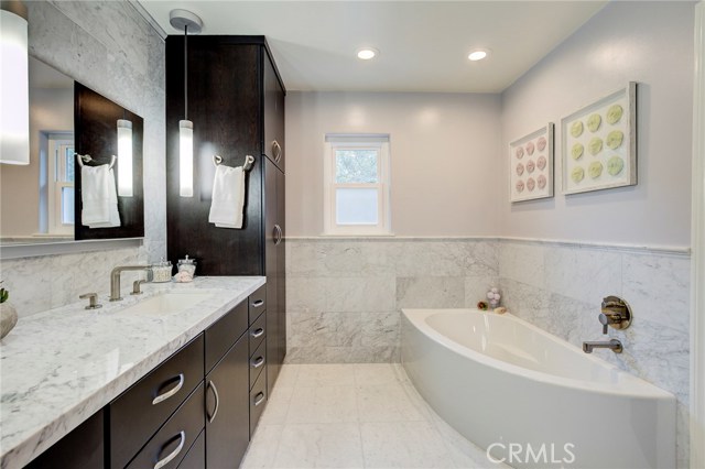 master bathroom with heated marble floors and marble countertops