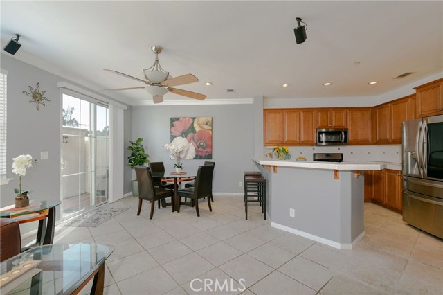 Sliding glass door leads to large back patio with a hot tub