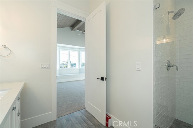 View of bedroom 1 with bay window from inside of bathroom.