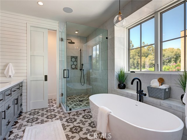 Master bathroom with dual sinks, walk-in shower, soaking tub, and water closet. Whole home surround sound.