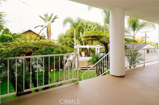 Lower rear deck leading to grassy backyard with spa.