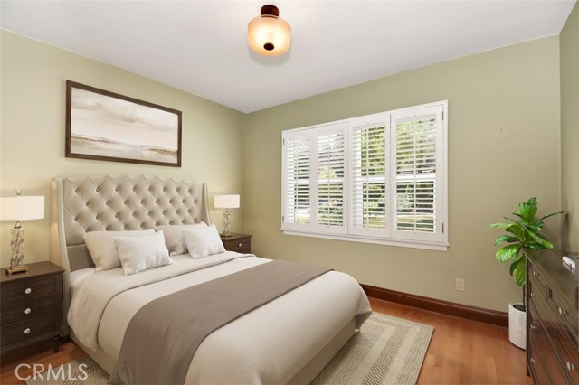 Second bedroom features newly refinished wood floors, plantation shutters, smooth ceilings and mirrored closet doors.