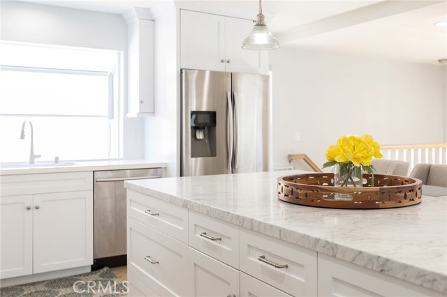 carrera marble countertop, stainless steel appliances