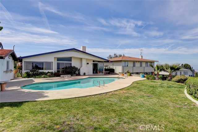 LOOKING BACK AT THE HOME FROM THE BACKYARD AND POOL.