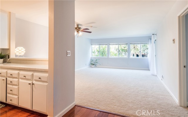 Beautiful wood floors in entry and kitchen, open to large living/dining room with trees & garden views.