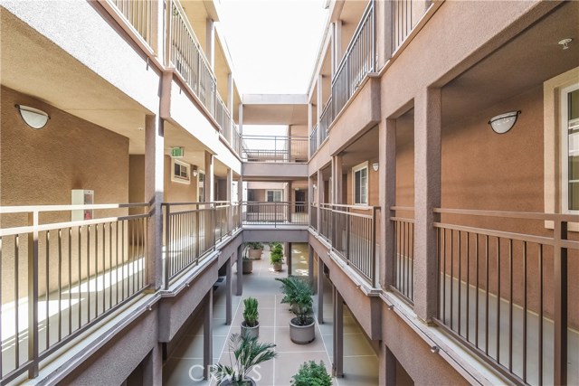 Walkway to front door of unit.  Well-kept complex.