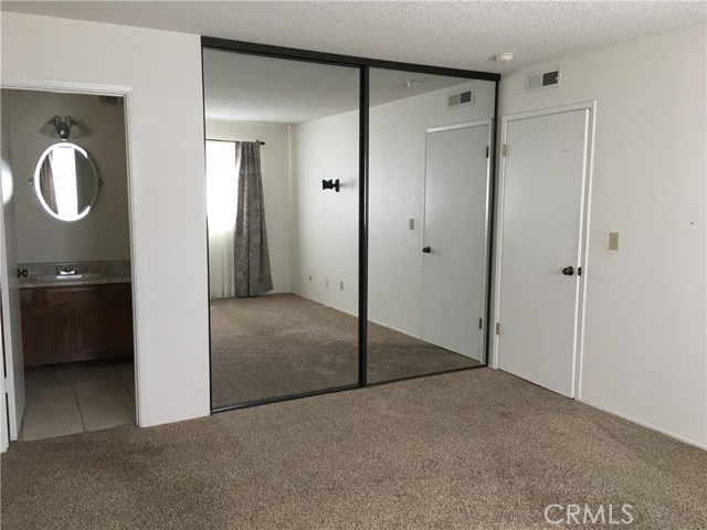 Mirrored closet doors and 3/4 Master Bath off Master Bedroom