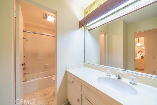 Bathroom 1 offers a full tub and shower with large vanity.