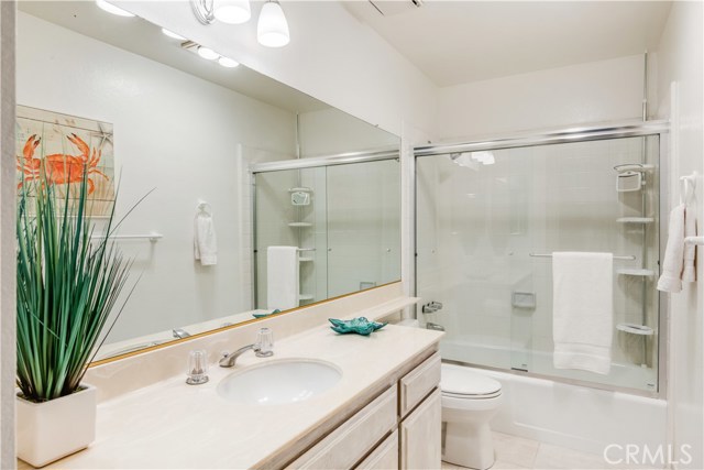 1st level bathroom with new glass bath enclosure.