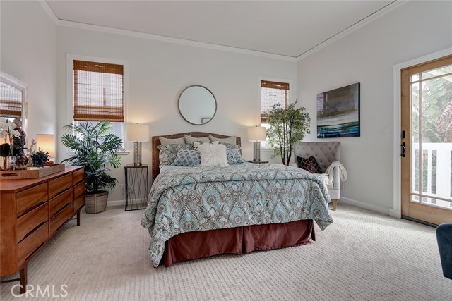 Peaceful master bedroom retreat with secluded balcony.