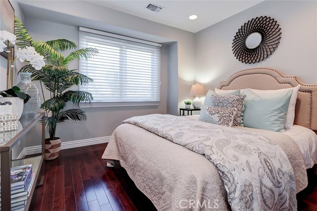 Light, bright and serene 2nd bedroom with frosted glass sliding closet doors, hardwood floors and recessed lighting.