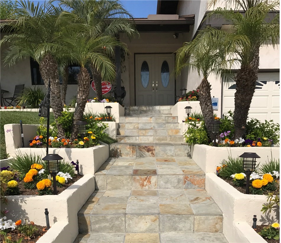 Front steps made of slate tile  lead you to your front door...