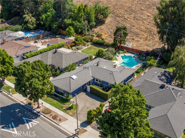 Aerial view of the large, flat 8400 sq ft lot with rolling hills in the backdrop