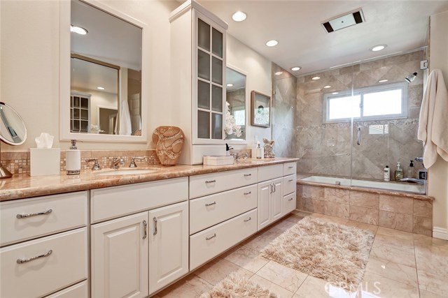 A large combo spa tub and shower make this master bathroom a relaxing and calming space.