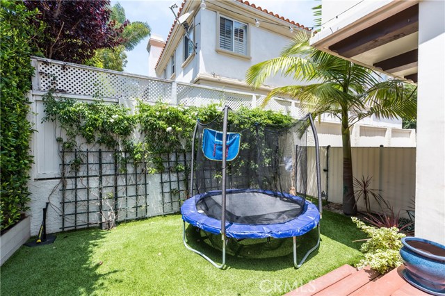 Grassy play area beyond is perfect for kids or pets to play!