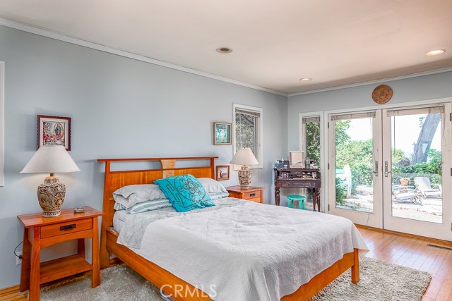 Bedroom with Anderson windows and doors open to yard