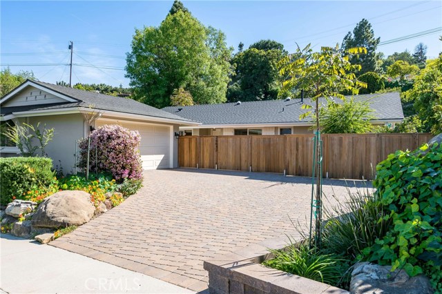 Colorful and eco-friendly landscape and beautiful paver driveway make for great curb appeal!