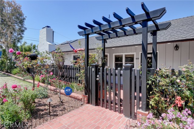 Wonderful corner lot provides a commanding presence - flowers flowers everywhere and a private gated entry!