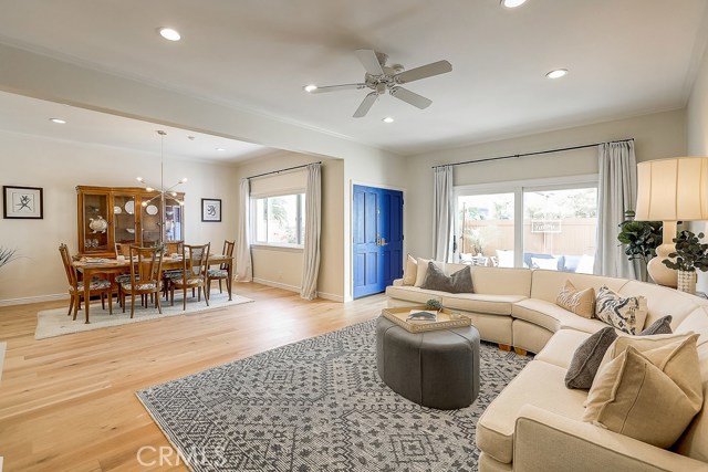Formal Living and Dining room showcasing White Oak Engineered wood floors with slider in background out to a charming patio!