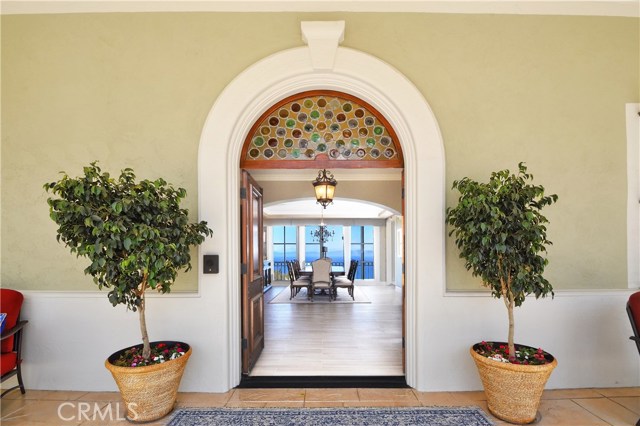 Front covered porch at the front door and looking across the formal dining room to the view.