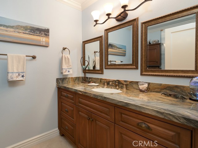 Hall bath with gorgeous granite countertop and cabinetry.  Bath was completely remodeled with new fixtures, mirrors, moldings, flooring, etc.