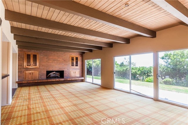 Huge recreation room with fireplace, built-ins and glass doors overlooking grassy rear yard.