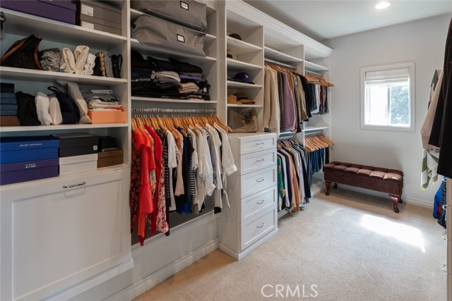 very large master closet with a window that provides light and ventilation