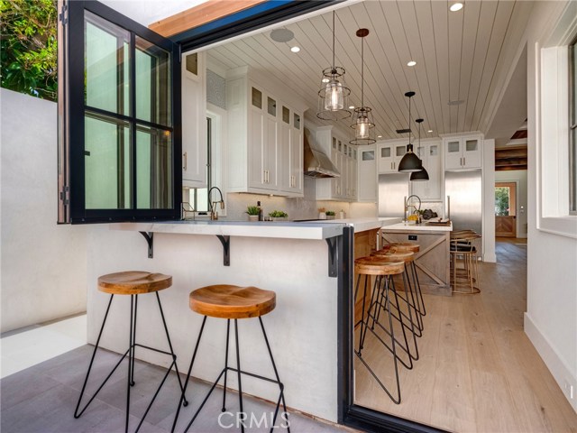 Indoor/outdoor bar & entertainment area that opens to backyard. Neolith stone counters, Thermador professional series appliances, dual sinks, additional beverage fridge, Brizo faucets, breakfast counter.