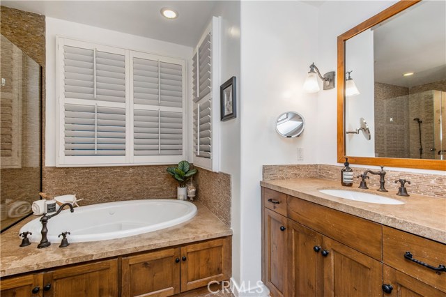 Plantation shutters surround the spa-like tub in the Master bathroom.