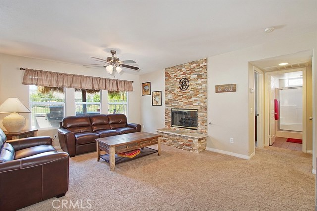 Wonderful family room with a wall of windows bringing the outdoors in.  Downstairs bedroom and bath through the hall