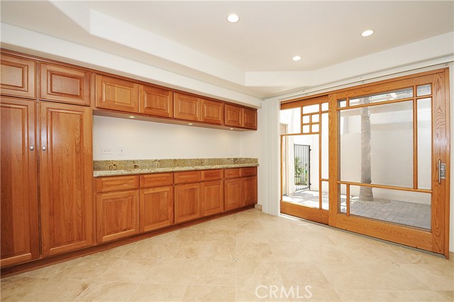 Dining Area with Serving Counter and Spacious Cabinets Looking into the Entry