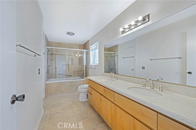 Full Bath features a long granite counter top, double sinks, and Oversized Tub with Shower and Grohe Fixtures.