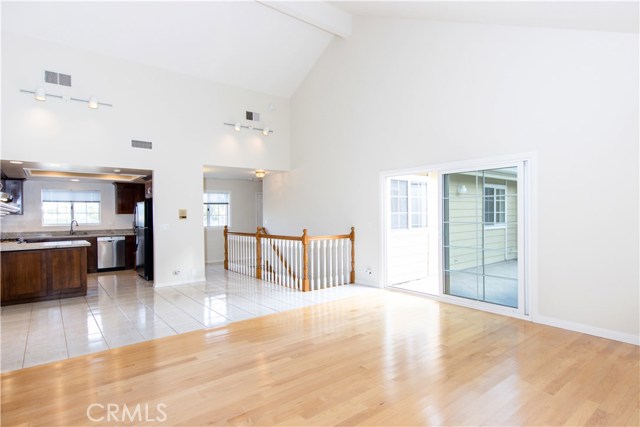 Open concept living room and kitchen with high ceilings