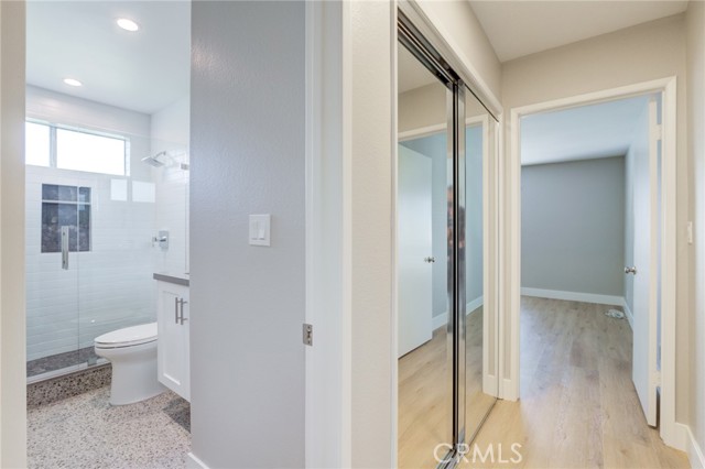 2nd bathroom with shower.  Mirrored doors (washer/dryer hookup location) and entrance to 2nd bedroom