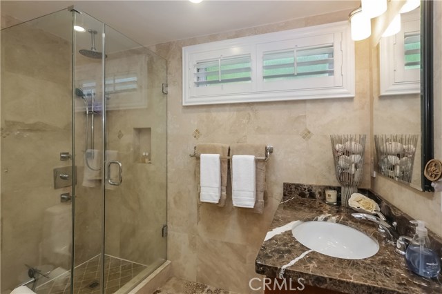 Guest bathroom with frameless shower doors.