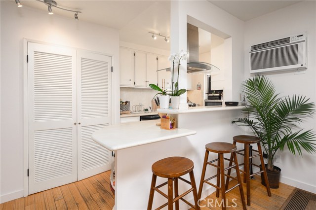 Breakfast bar with laundry (stack washer and dryer included) in closet