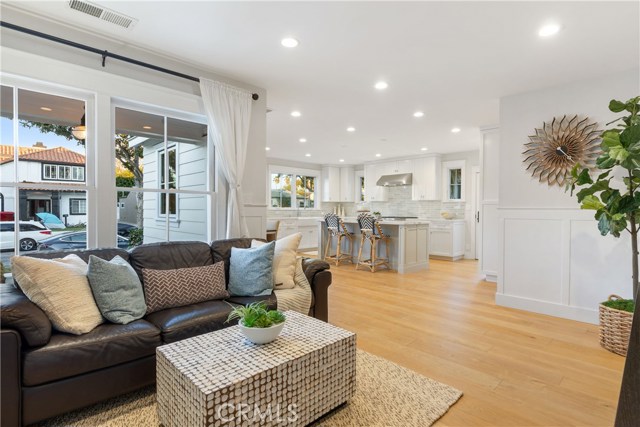 The bright and open great room includes custom wide plank French oak floors and wainscoting that bring warmth and character to the space.