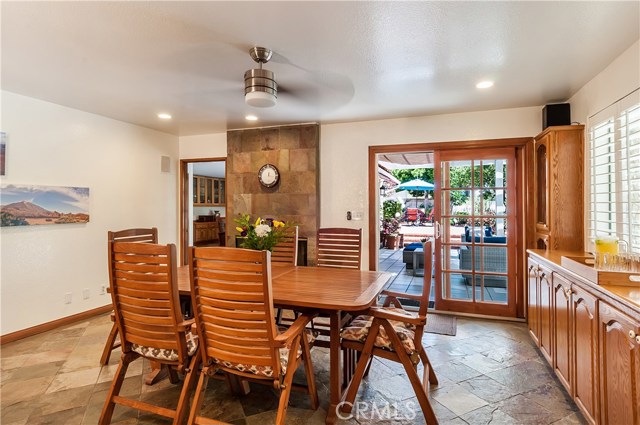 Casual dining area adjacent to kitchen with built-in cabinetry + yard/patio access.