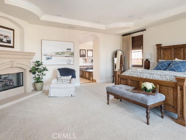 Primary bedroom with fireplace and ensuite.