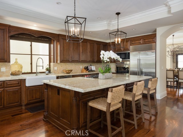 Large kitchen has a wolf cook top, ovens and large center island.