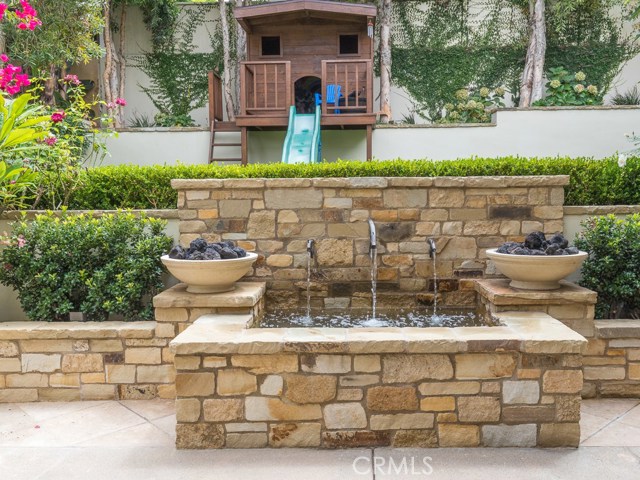 View of the fountain with lighting and play area.