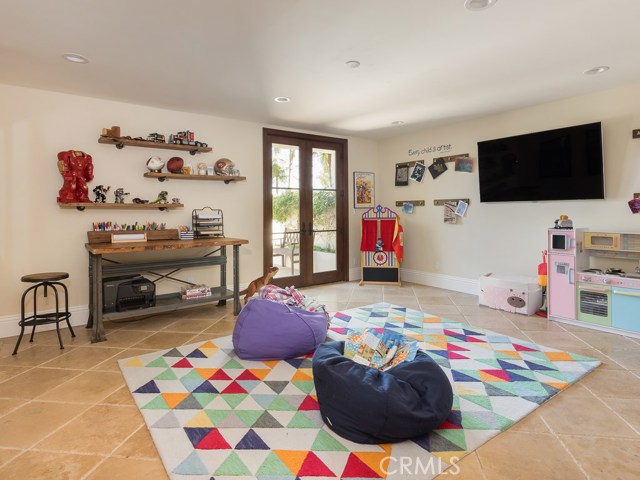 Downstairs bedroom can be a play room, office or gym. The room opens to a lovely courtyard.