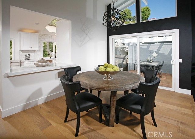 Dining room: Ocean View-Freshly painted-Black Accent Wall-New dual pane windows-Matte Black Kelly Wearstler Cubist Small Chandelier-New Decora outlets and switches-New 6 inch base boards-New Copa Coast hardwood floor.