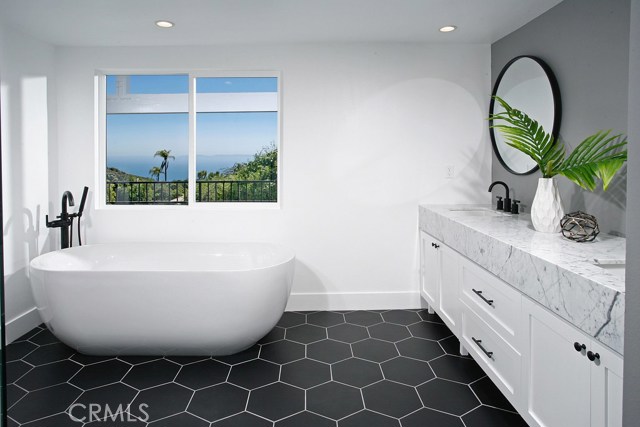 Master Bathroom: Ocean and Catalina Views-New expanded/enlarged-Freshly painted-New exhaust fans-New air vents-New dual pane windows-New recessed lights-New cabinets with shaker doors-Accent Wall-New Matte Black Mayfair round mirror-New Statuarietto marble counter tops-New Matte Black sink faucet and trim-New Freestanding soaking bathtub-New Matte Black floor mount faucet-New White ceramic tile shower-New 3/8 thick frameless shower glass with matte black hardware-New low flow Toto commodes-New Decora outle