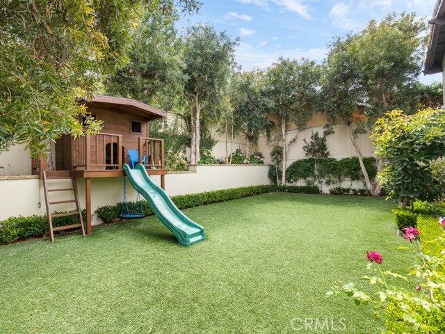 Expansive upper yard area with custom landscape design.